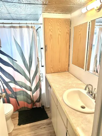 a bathroom with a sink toilet and shower