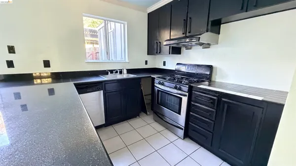 a kitchen with stainless steel appliances a stove a sink and a microwave
