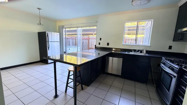 a kitchen with a sink a counter top space and stainless steel appliances