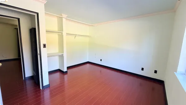 a view of a room with wooden floor