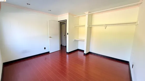 a view of a room with wooden floor