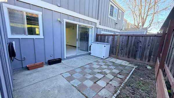a view of a house with backyard and wooden fence