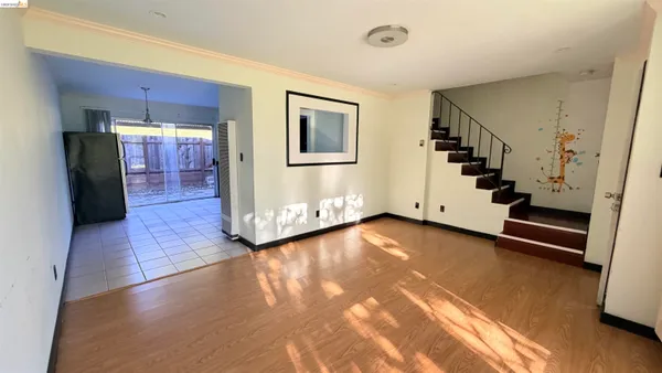 a view of an entryway with wooden floor and stairs