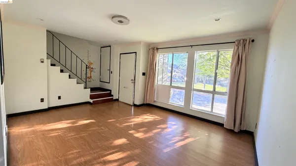 a view of a room with window and stairs