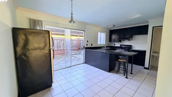 a kitchen with stainless steel appliances a refrigerator a sink a stove a microwave and cabinets