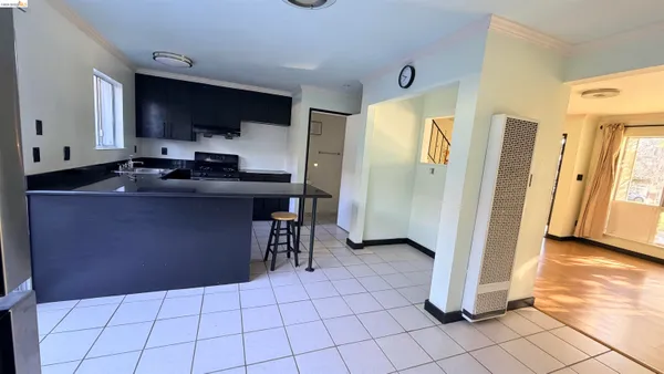 a kitchen with stainless steel appliances a sink a stove a refrigerator a microwave and cabinets