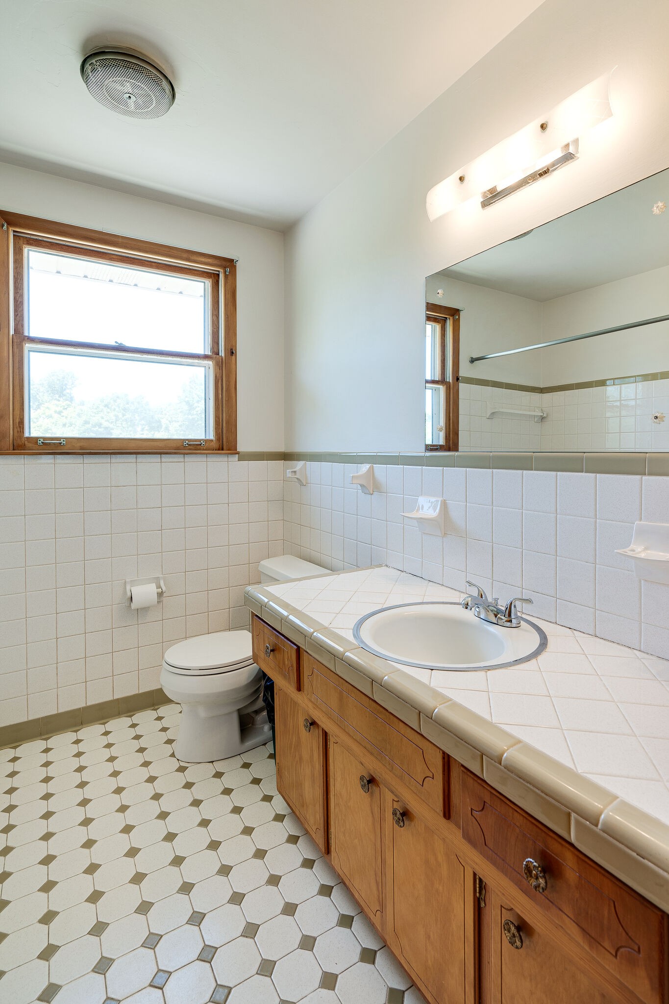 7524 Gary Road Joelton, TN 37080 - Photo 18 of 29 a bathroom with a granite countertop sink a toilet and a mirror