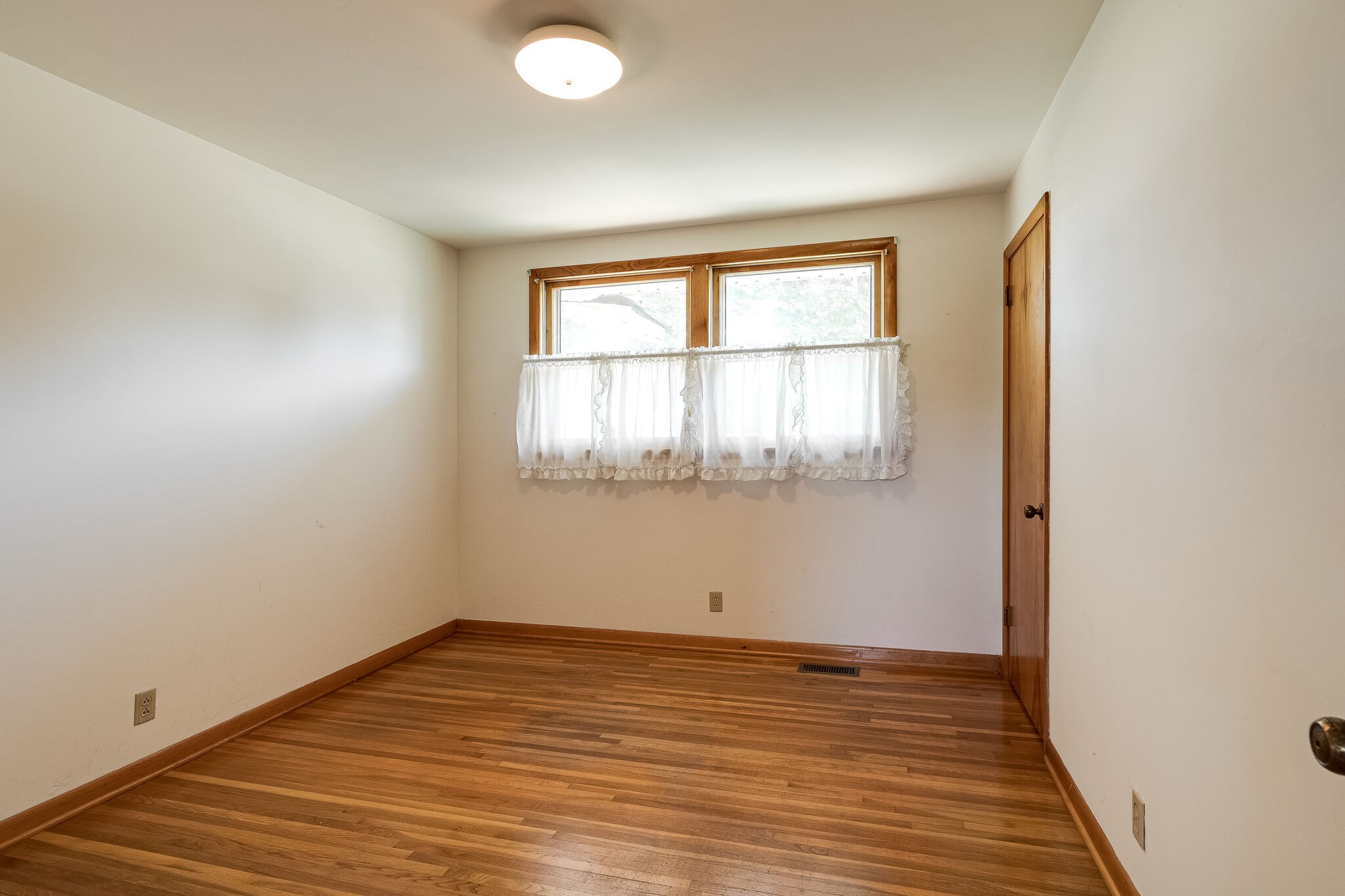 7524 Gary Road Joelton, TN 37080 - Photo 20 of 29 an empty room with wooden floor and windows