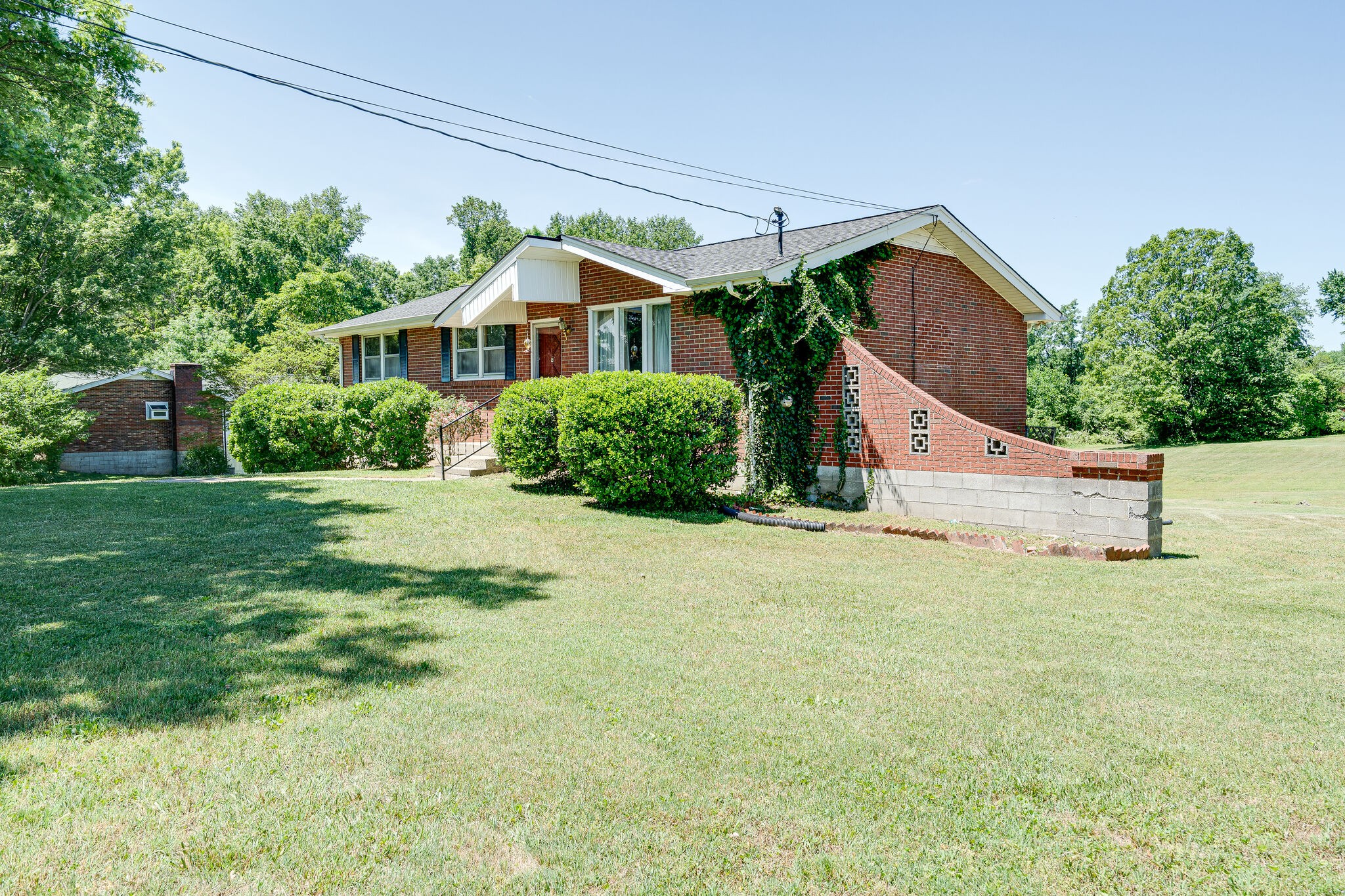 7524 Gary Road Joelton, TN 37080 - Photo 3 of 29 a front view of a house with a yard and garage