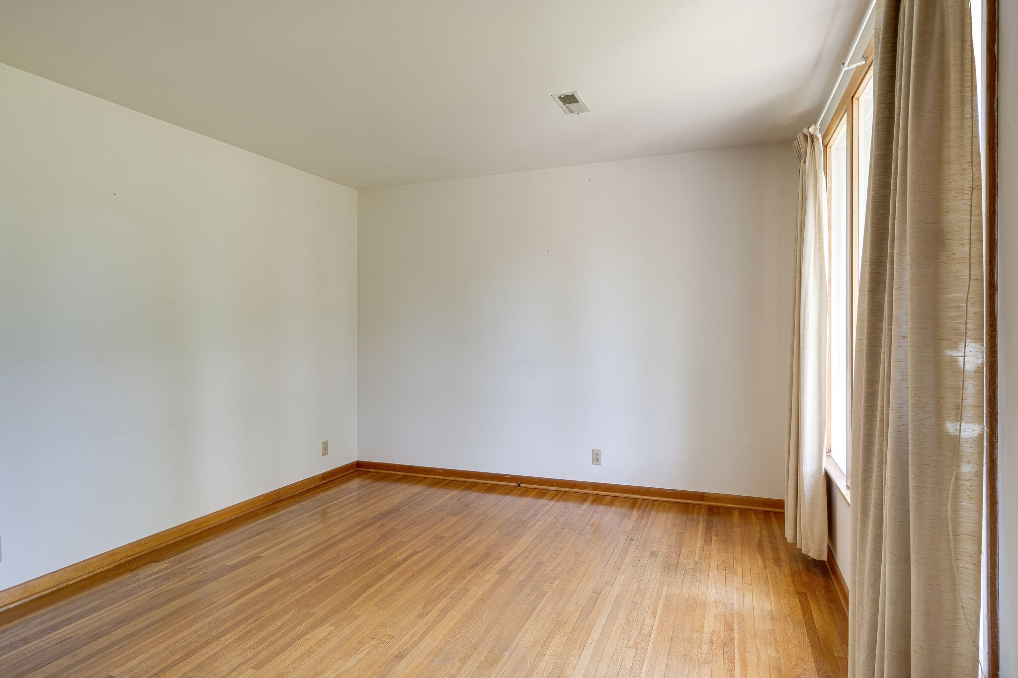 7524 Gary Road Joelton, TN 37080 - Photo 7 of 29 a view of an empty room with wooden floor and a window