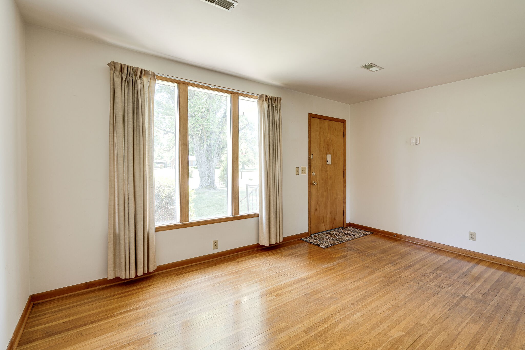 7524 Gary Road Joelton, TN 37080 - Photo 8 of 29 an empty room with wooden floor and windows