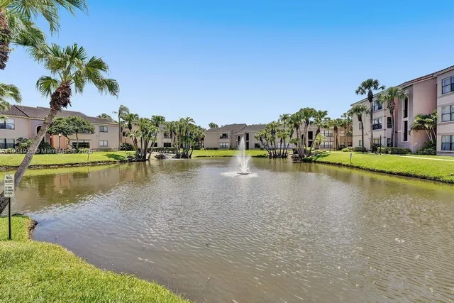 an aerial view of a house with a garden and lake view