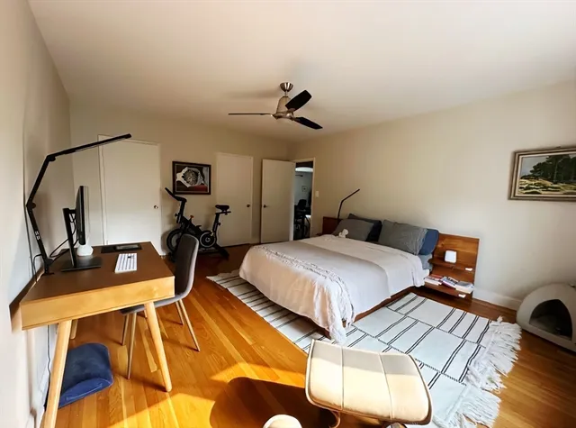 a bedroom with a bed and wooden floor