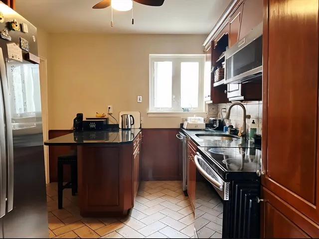 a kitchen with a sink appliances and cabinets