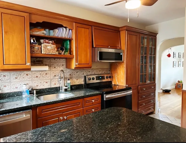 a kitchen with stainless steel appliances granite countertop a stove and a sink