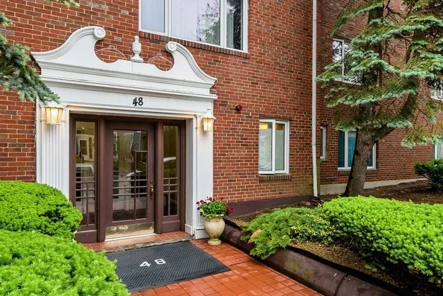front view of a brick house with a large windows