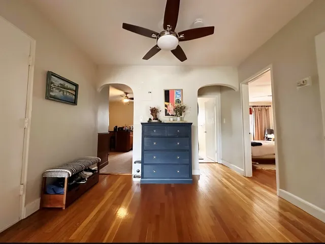 a living room with furniture and a wooden floor