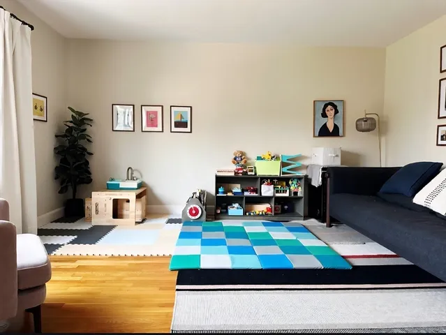 a room with kitchen island stainless steel appliances and living room view