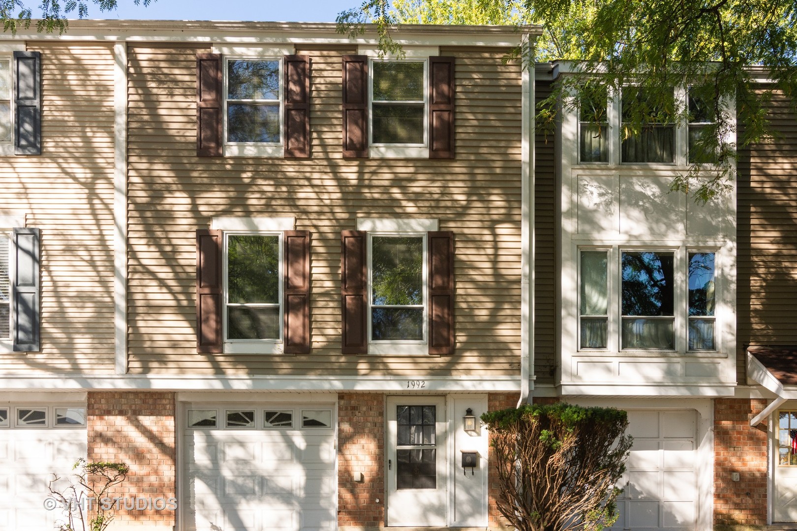 a picture of a brick house with a large window