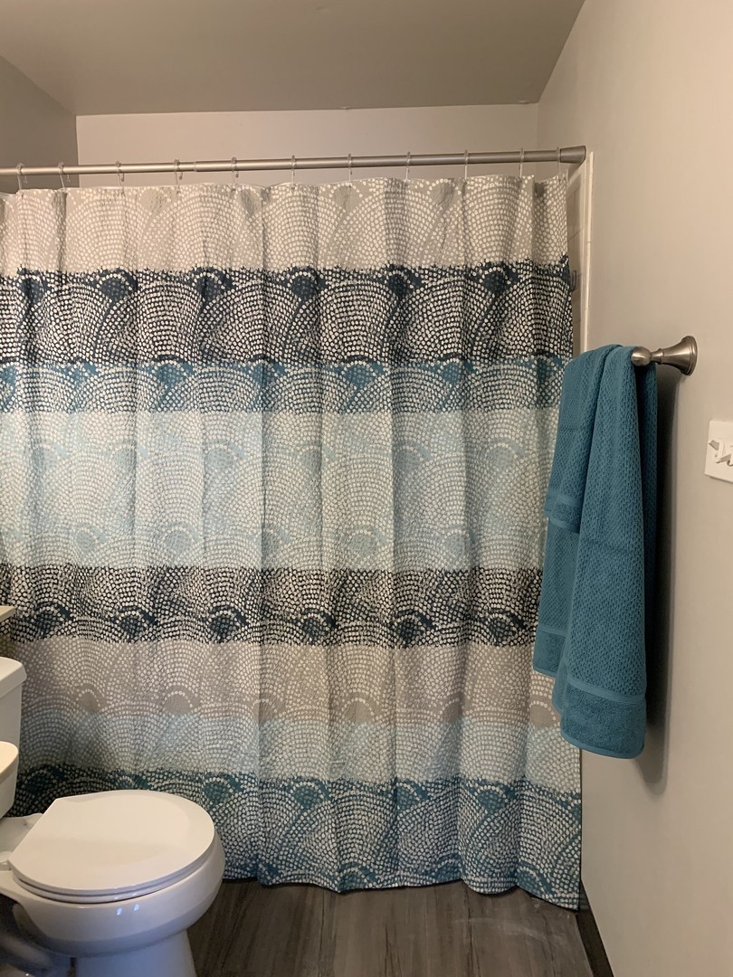 1992 Holbrook Lane Hoffman Estates, IL 60169 - Photo 9 of 14 a bathroom with a toilet and a shower