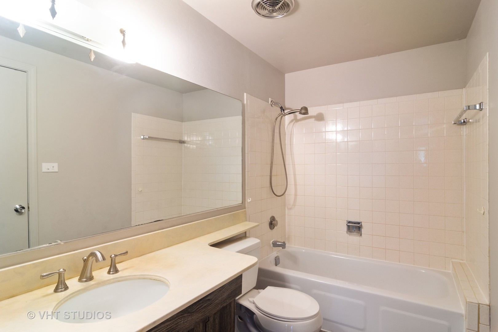 1992 Holbrook Lane Hoffman Estates, IL 60169 - Photo 10 of 14 a bathroom with a bathtub shower sink mirror vanity and a toilet