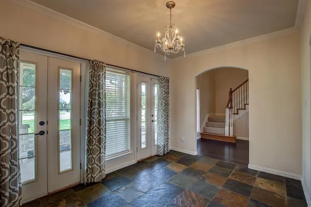 a dining hall with stainless steel appliances granite countertop a stove and a wooden floors