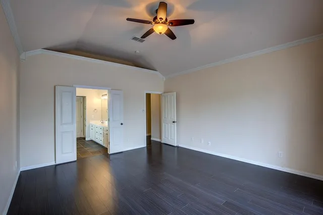 a spacious bathroom with double vanity and a mirror