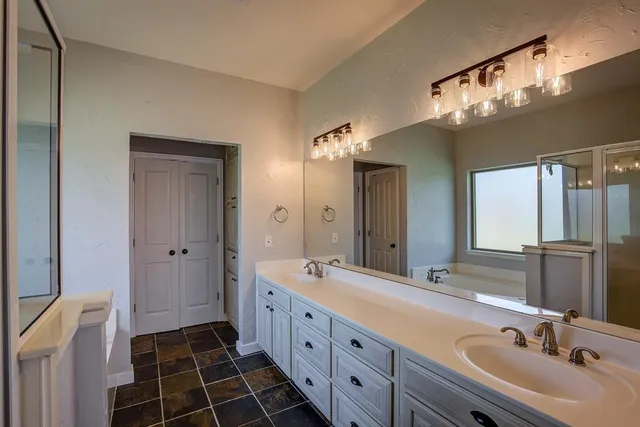 a bathroom with a mirror and a bathtub