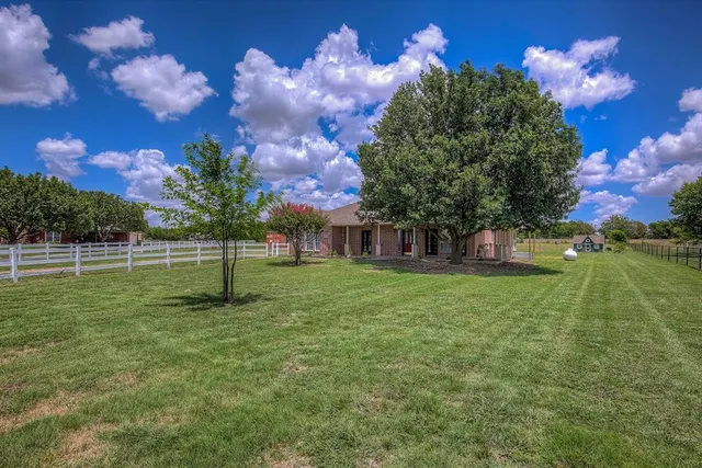 a view of a house with a backyard