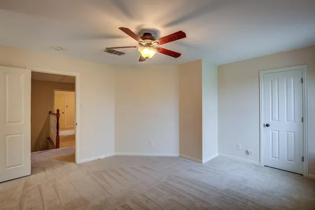 a view of a livingroom with a ceiling fan and window