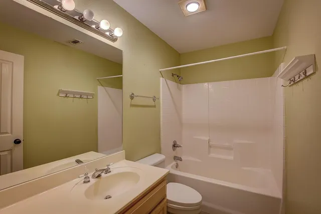 a view of empty room with a fan