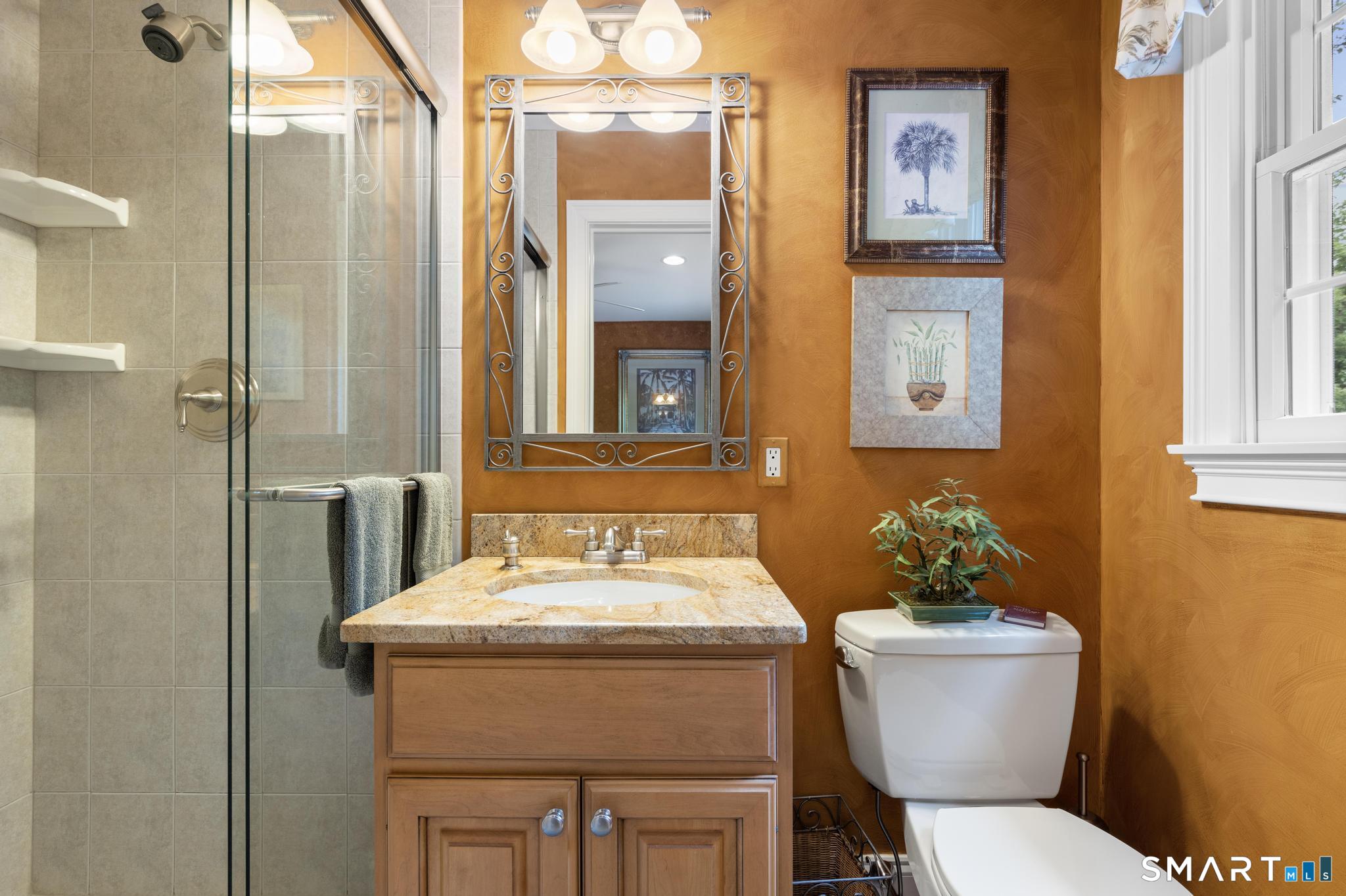 12 Logans Way Danbury, CT 06811 - Photo 30 of 40 a bathroom with a toilet sink and mirror