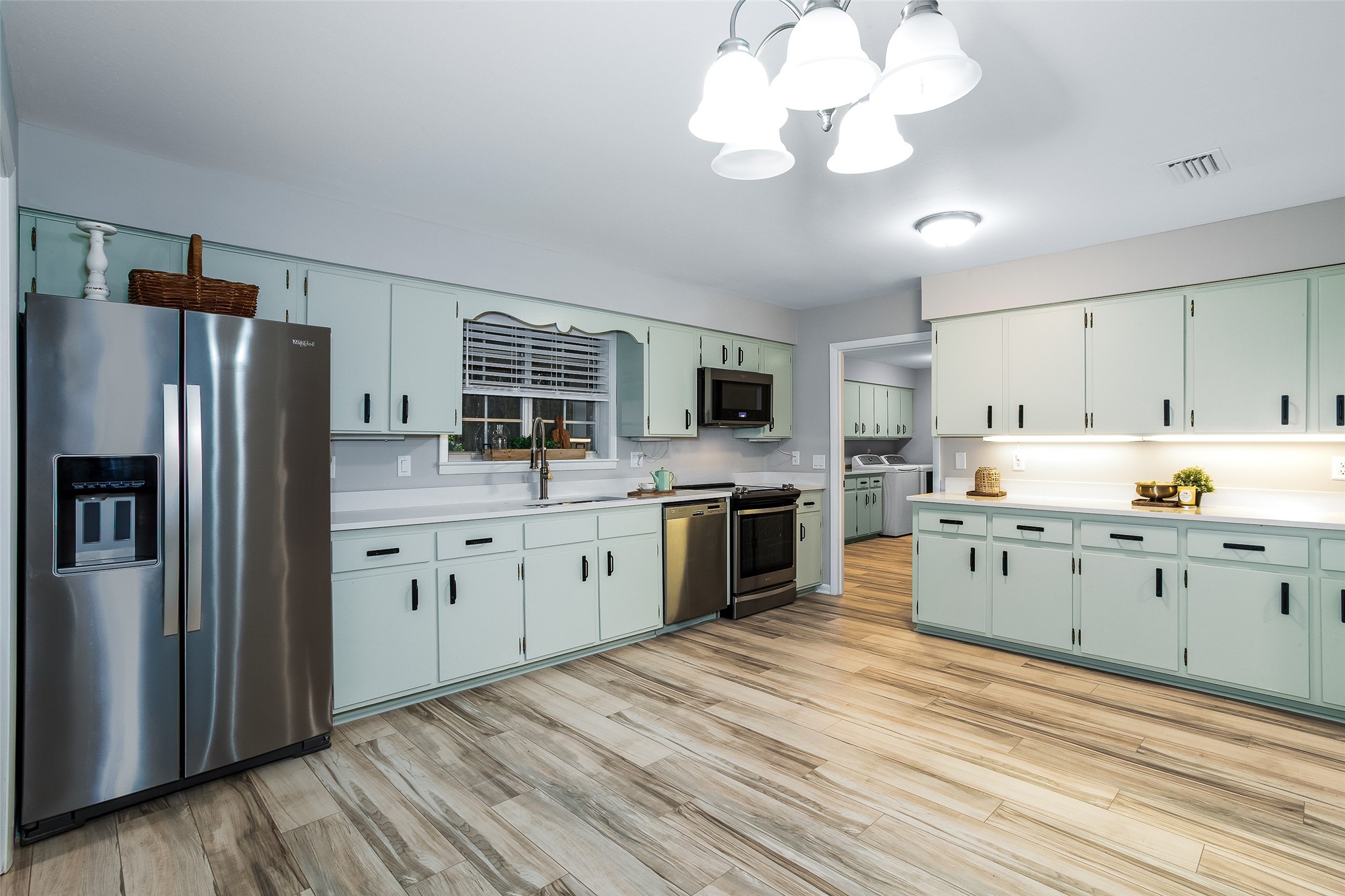 28175 Hammock Road Hilliard, FL 32046 - Photo 8 of 33 a kitchen with a refrigerator sink and dishwasher with wooden floor