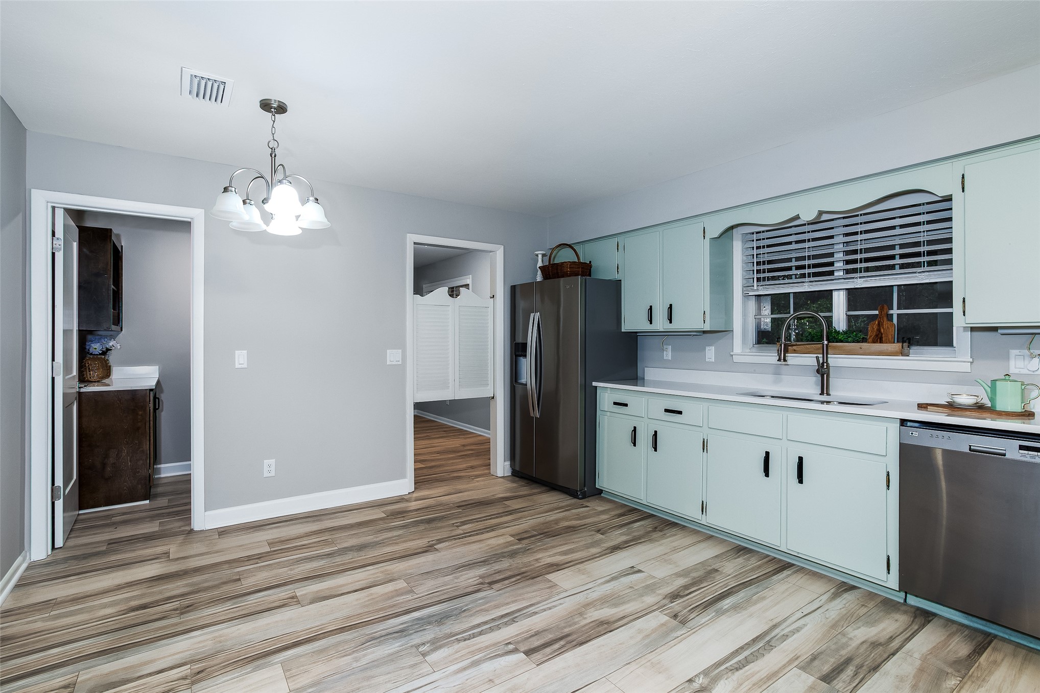 28175 Hammock Road Hilliard, FL 32046 - Photo 9 of 33 a kitchen with stainless steel appliances granite countertop a sink stove and refrigerator
