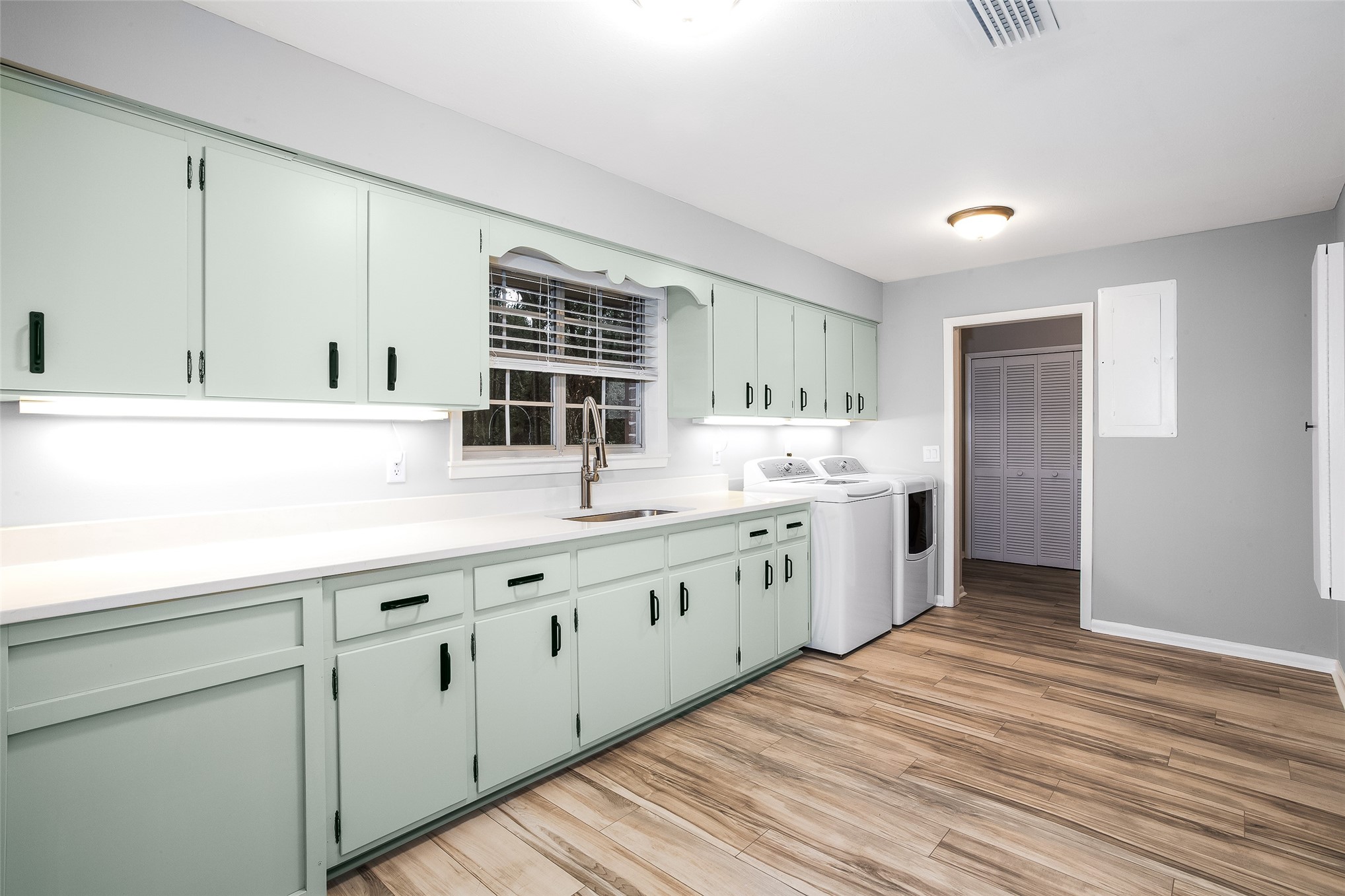 28175 Hammock Road Hilliard, FL 32046 - Photo 10 of 33 a kitchen with granite countertop white cabinets and white appliances