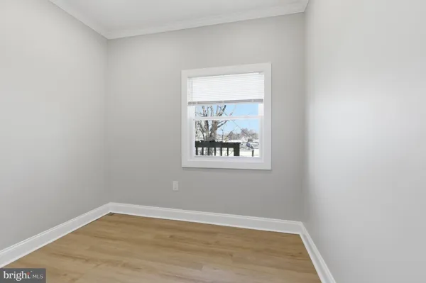 a view of a small space with wooden floor and a window