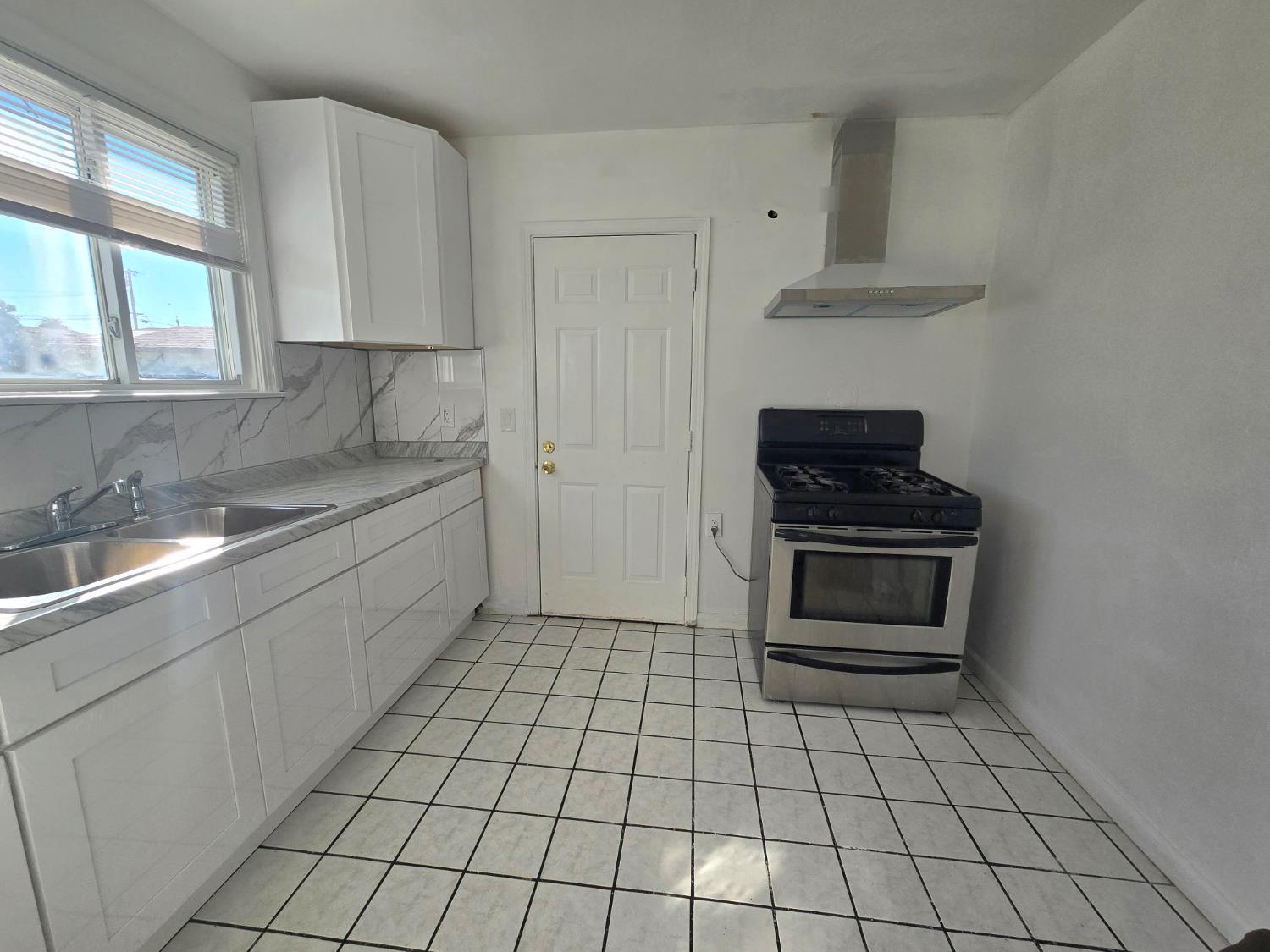 320 North Sanborn Road Salinas, CA 93905 - Photo 13 of 26 a kitchen with a sink a stove and cabinets