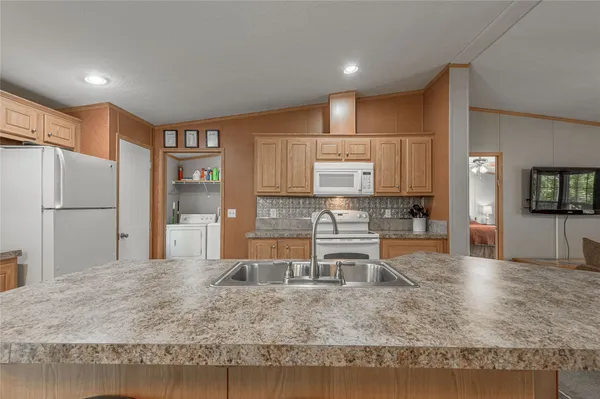 a kitchen with a table chairs and wooden floor