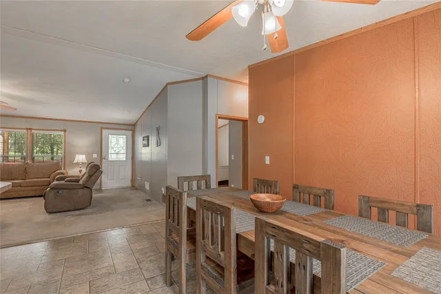 a spacious bedroom with a bed and a chandelier