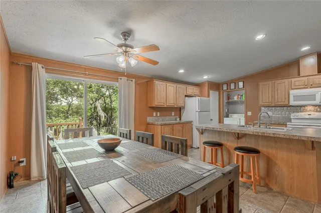 a bathroom with a granite countertop sink a mirror and a toilet
