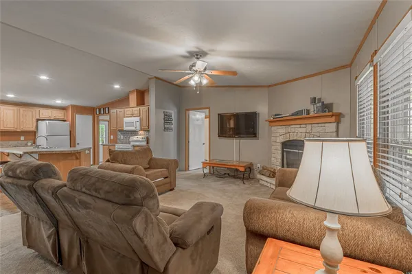 a living room with furniture a flat screen tv and a fireplace