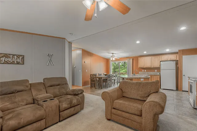 a kitchen with a refrigerator sink and cabinets