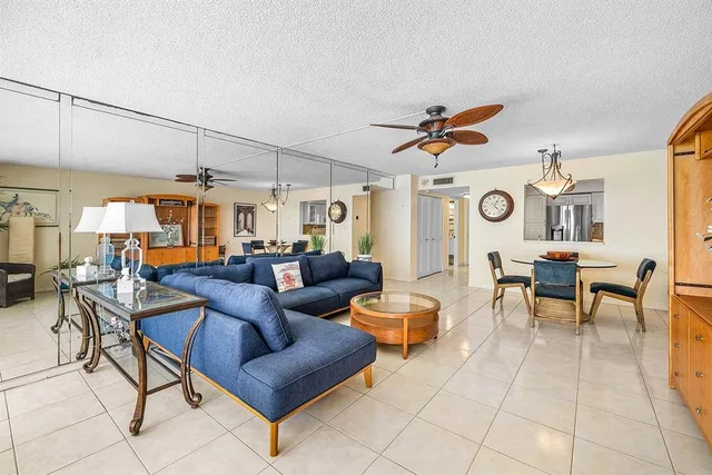 a living room with furniture a rug and a window