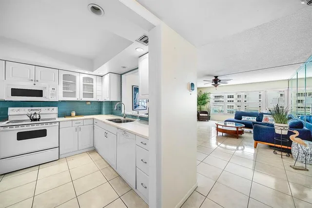 a kitchen with white cabinets and white appliances
