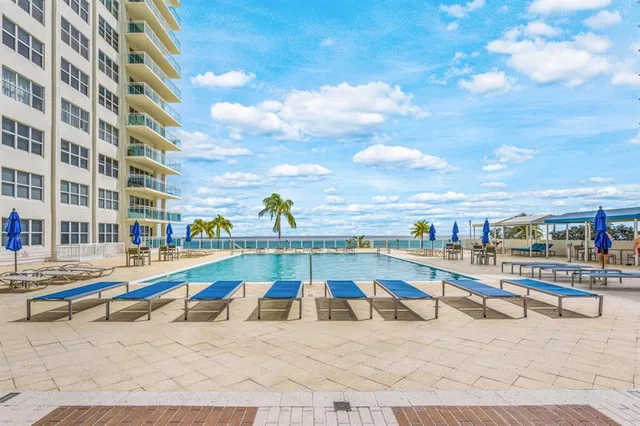 a view of a swimming pool with an outdoor seating