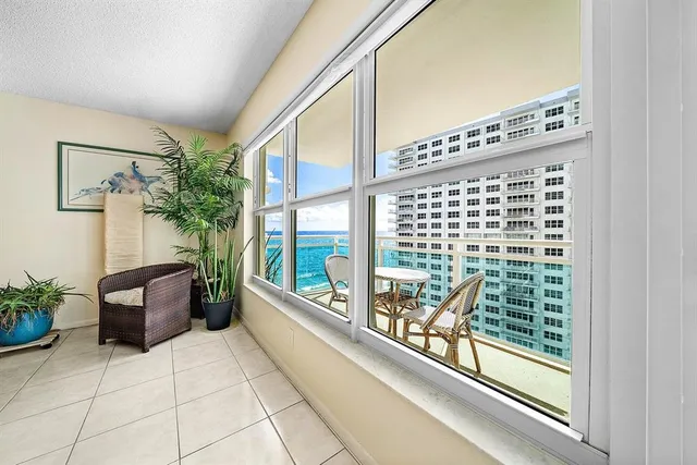 a view of a chairs and table in a balcony