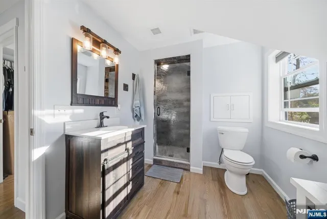 a kitchen with kitchen island white cabinets and stainless steel appliances