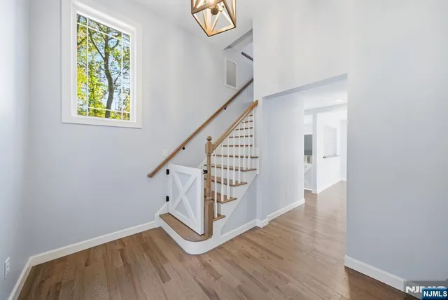 a view of entryway with wooden floor and stairs