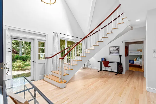 a view of entryway and hall with wooden floor