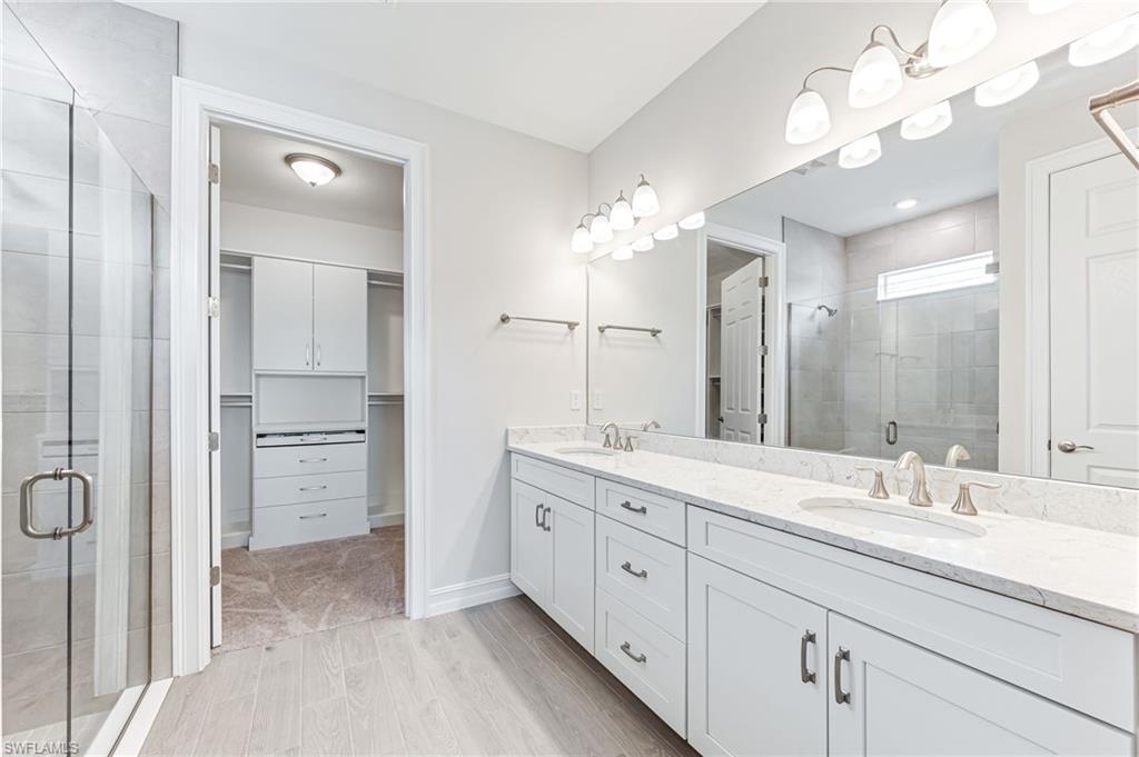 475 Polihale Way Naples, FL 34114 - Photo 17 of 27 a spacious bathroom with a double vanity sink mirror and a shower
